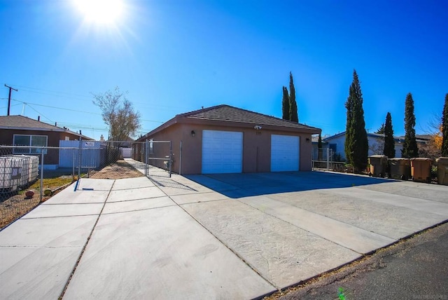 view of side of property with a garage and an outbuilding