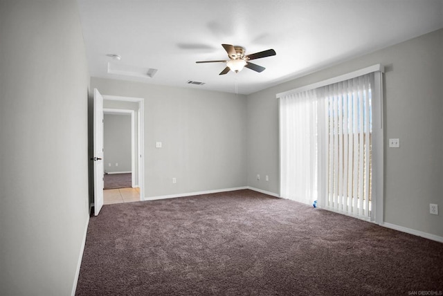 spare room with ceiling fan, light carpet, and a wealth of natural light