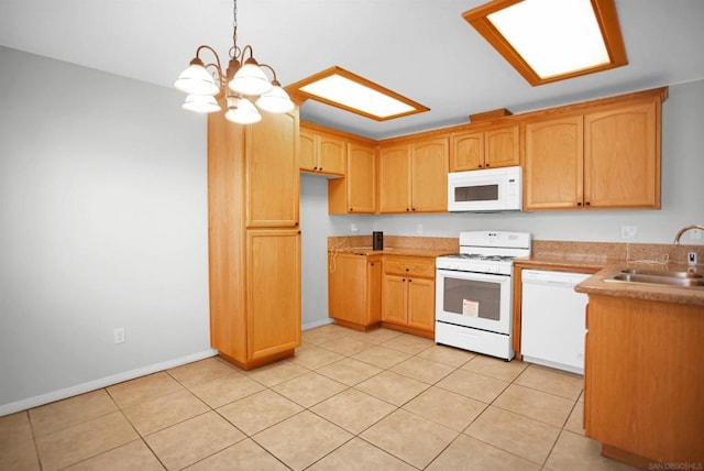 kitchen featuring sink, hanging light fixtures, a chandelier, white appliances, and light tile patterned floors