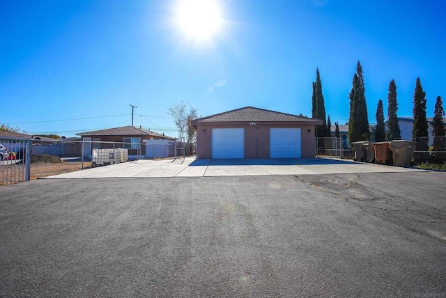 ranch-style house with a garage and an outbuilding