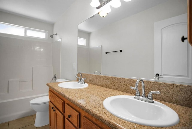 full bathroom featuring tile patterned flooring, vanity, toilet, and  shower combination