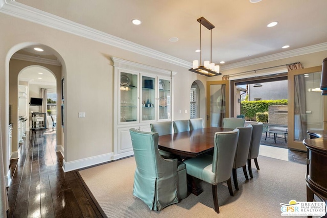 dining area with hardwood / wood-style floors and crown molding