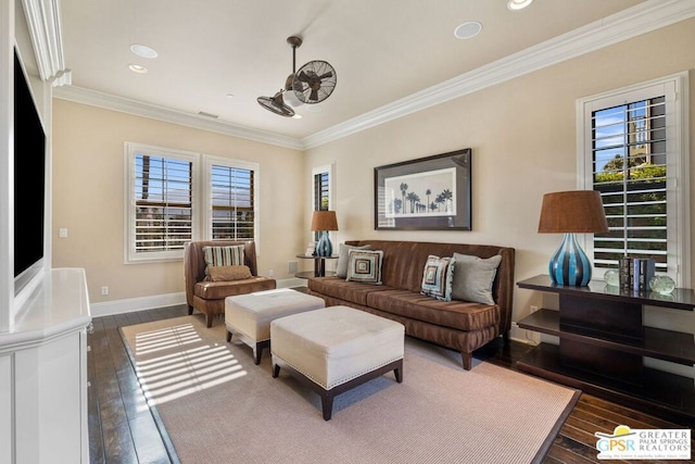 living room featuring dark hardwood / wood-style flooring, a wealth of natural light, and ornamental molding