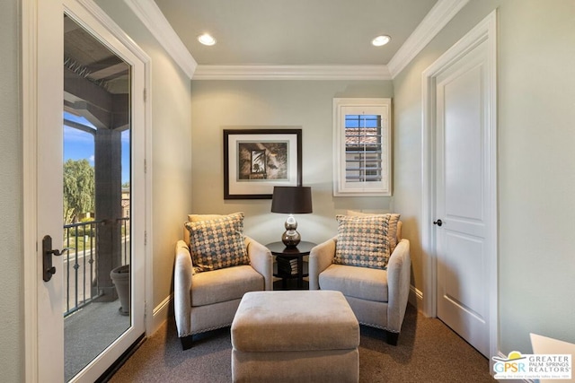 sitting room with crown molding and dark carpet