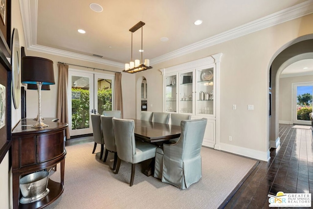 dining room with dark hardwood / wood-style flooring and ornamental molding