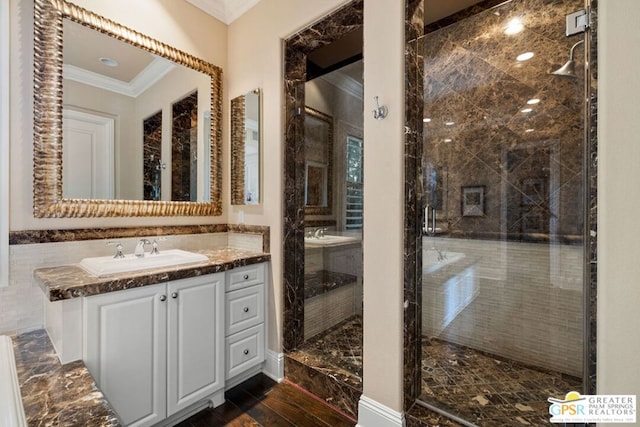 bathroom featuring ornamental molding, tile walls, an enclosed shower, and vanity