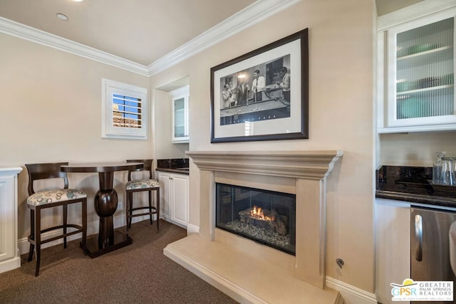 living area with dark colored carpet and crown molding