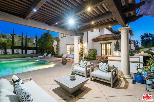 view of patio / terrace featuring french doors, an outdoor living space, and a fenced in pool