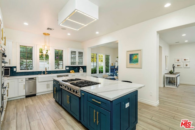 kitchen featuring white cabinetry, blue cabinets, and stainless steel gas cooktop