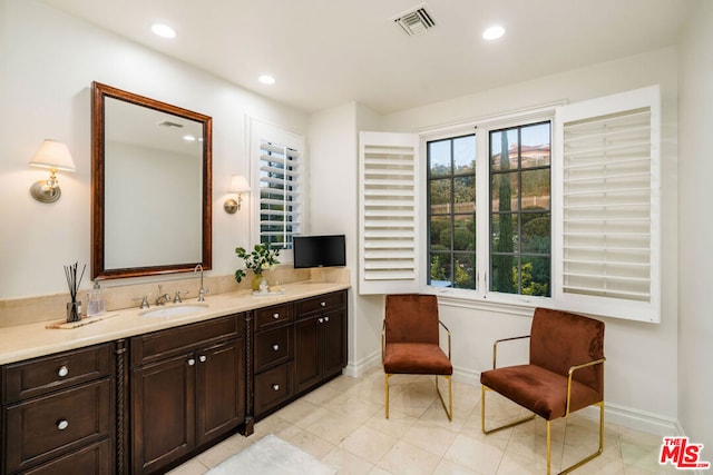 bathroom featuring tile patterned flooring and vanity