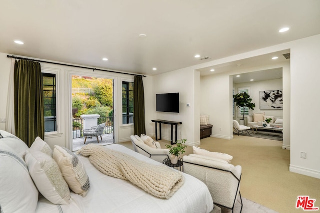 bedroom featuring access to exterior and light colored carpet