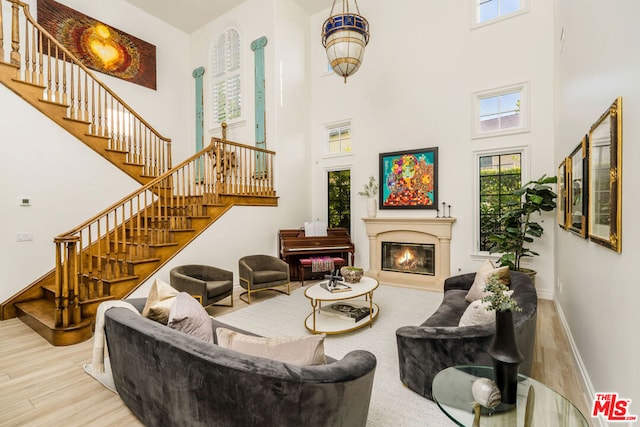 living room with wood-type flooring and a high ceiling