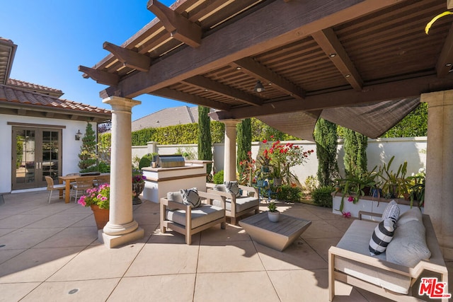 view of patio featuring outdoor lounge area, an outdoor kitchen, a pergola, and french doors