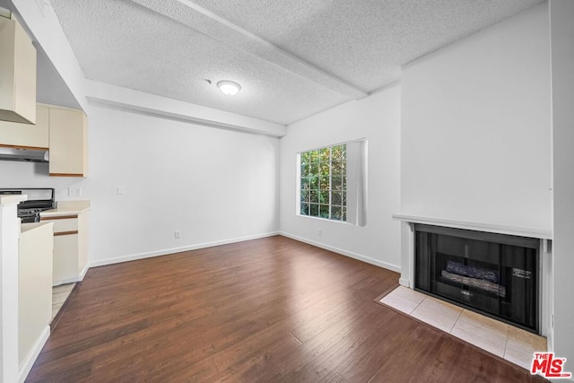 unfurnished living room with light hardwood / wood-style floors and a textured ceiling