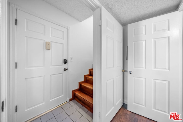 entrance foyer with wood-type flooring and a textured ceiling