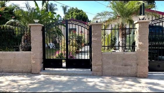 view of gate featuring fence