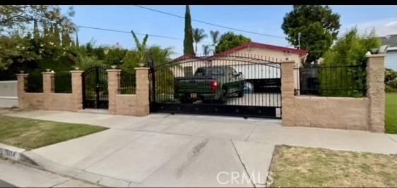 view of gate with a fenced front yard