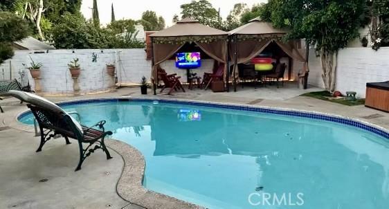 view of pool featuring a gazebo, a fenced in pool, a patio area, and a fenced backyard
