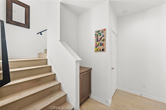 stairway with hardwood / wood-style flooring