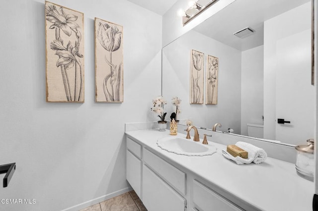 bathroom featuring tile patterned floors, vanity, and toilet