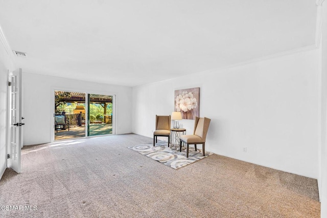 living area featuring carpet flooring and ornamental molding