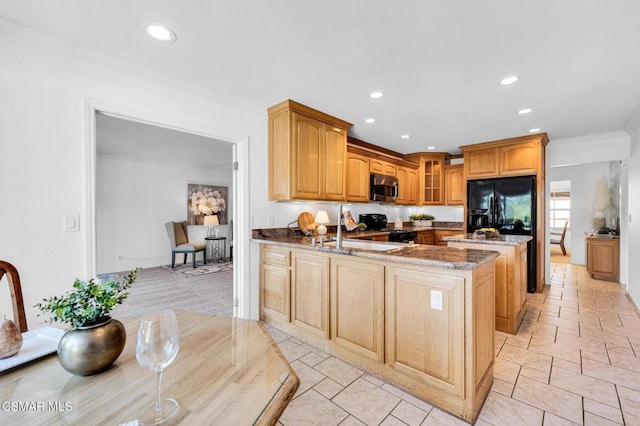 kitchen featuring black appliances, crown molding, sink, stone countertops, and kitchen peninsula