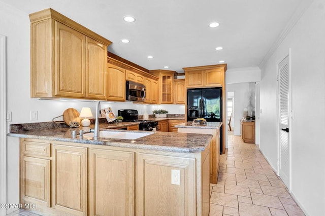 kitchen with kitchen peninsula, light stone counters, ornamental molding, sink, and black appliances