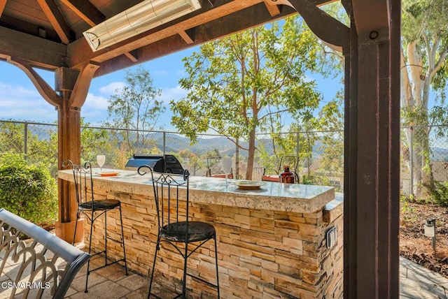 view of patio featuring a bar and area for grilling