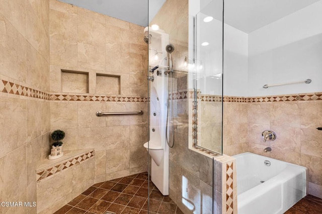 bathroom featuring tile patterned floors, independent shower and bath, and tile walls