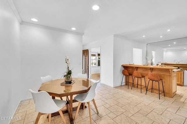 dining room with crown molding and indoor bar