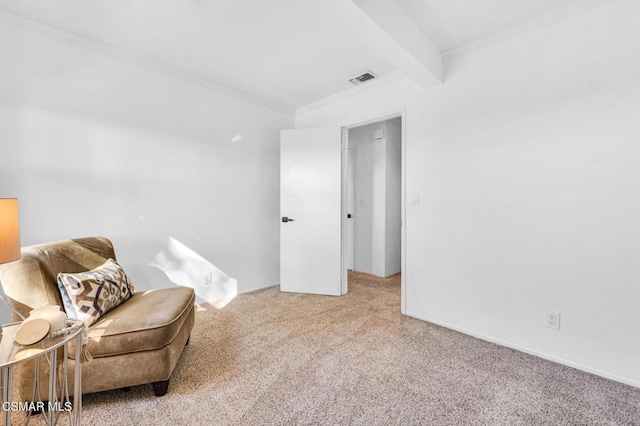 sitting room with beamed ceiling, carpet floors, and ornamental molding