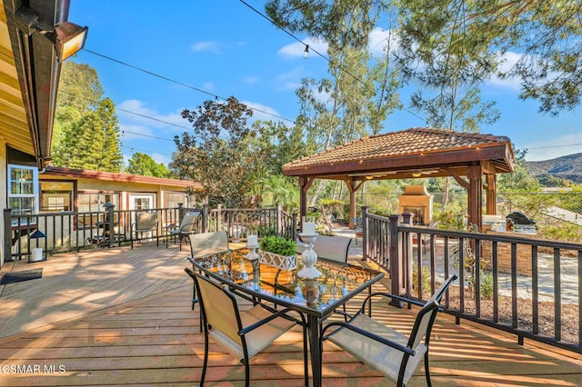 wooden deck featuring a gazebo and a mountain view