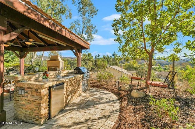 view of patio / terrace with a gazebo, a grill, ceiling fan, and an outdoor kitchen