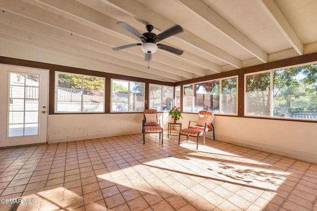 unfurnished sunroom with vaulted ceiling with beams, ceiling fan, and a healthy amount of sunlight