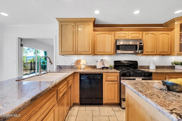 kitchen featuring light stone countertops, appliances with stainless steel finishes, light tile patterned floors, and sink