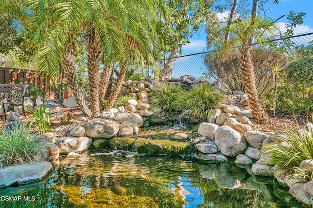 view of yard with a garden pond