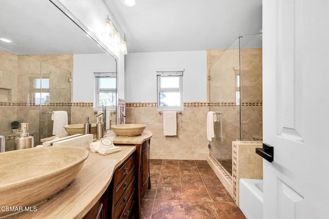 bathroom featuring tile patterned flooring, vanity, separate shower and tub, and tile walls