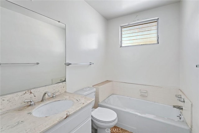 bathroom featuring a washtub, toilet, and vanity