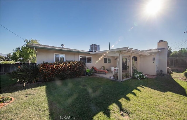 back of house with a pergola, central AC, and a lawn