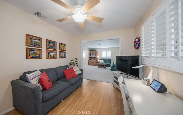 living room with ceiling fan and light hardwood / wood-style floors