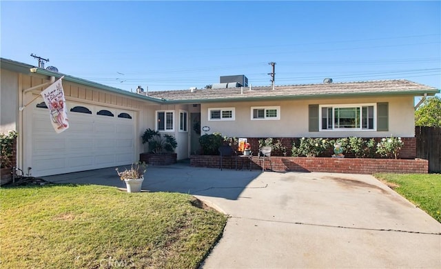 single story home with a front yard and a garage