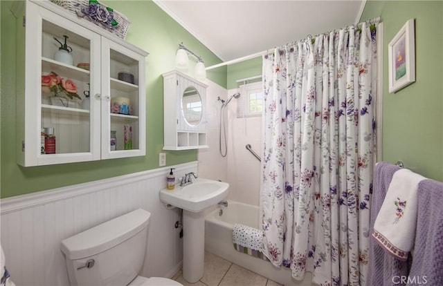 bathroom featuring tile patterned floors, crown molding, shower / bath combo, and toilet