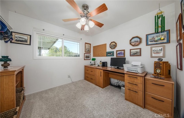 carpeted office featuring ceiling fan