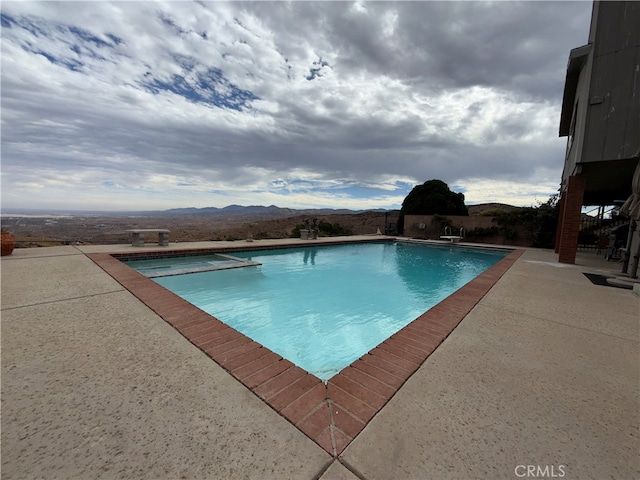 view of pool featuring a patio and a mountain view