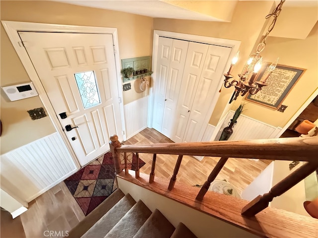 entrance foyer with hardwood / wood-style flooring and an inviting chandelier