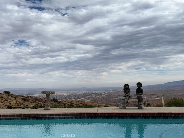 view of pool with a mountain view