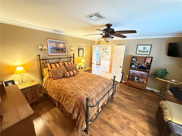 bedroom featuring ceiling fan, crown molding, and wood-type flooring