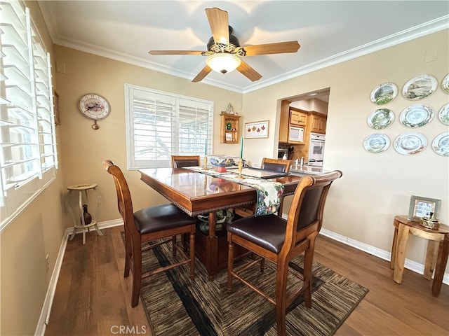 dining area featuring crown molding, wood-type flooring, and ceiling fan