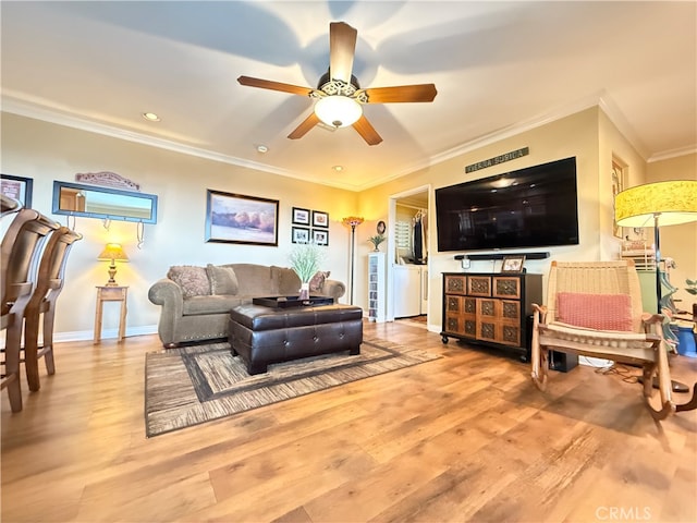 living room with crown molding, light hardwood / wood-style flooring, and ceiling fan