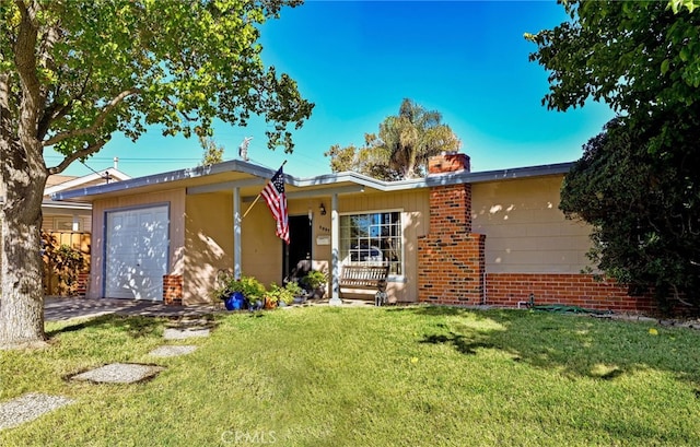 single story home with a garage and a front lawn